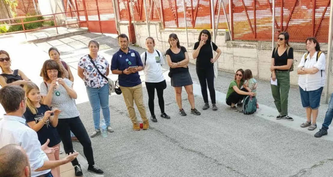 A group of residents, city officials and practitioners gathered outdoors during a neighbourhood workshop - an image of collaborative delivery.